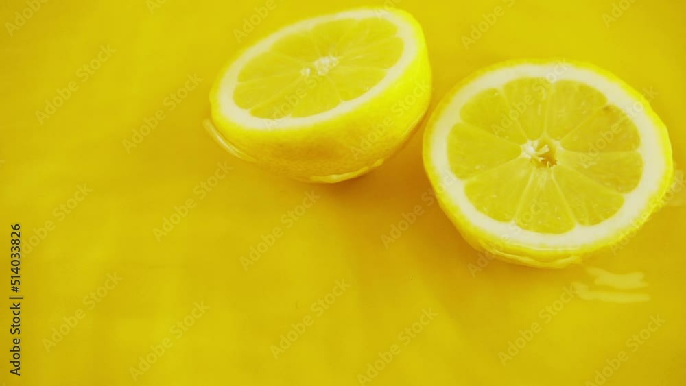 Rotating segments of a ripe and juicy lemon on an orange background. Slow motion. Rotating segments of a ripe and juicy lemon on an orange background. Slow motion.