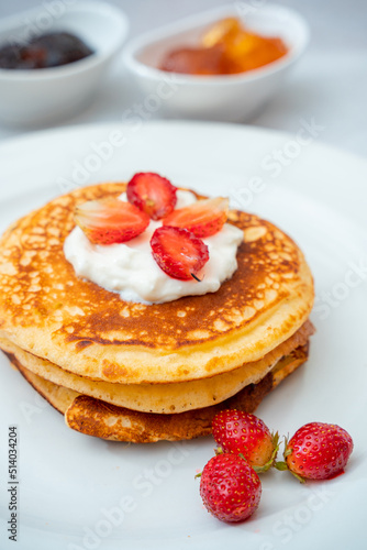 Pancakes with berries and maple syrup