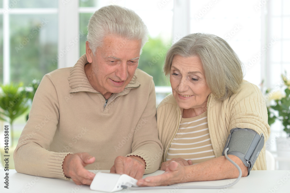 Senior couple measuring blood pressure together Senior couple measuring blood pressure together