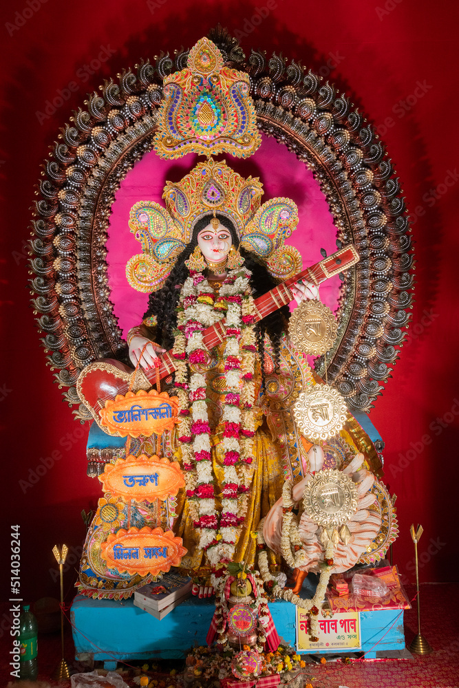 Fototapeta premium Kolkata,West Bengal,India - 10th February 2019 : Idol of Goddess Saraswati with veena, a musical instrument and white swan, a sacred bird. Hindu goddess of knowledge, music, art, wisdom, and learning.