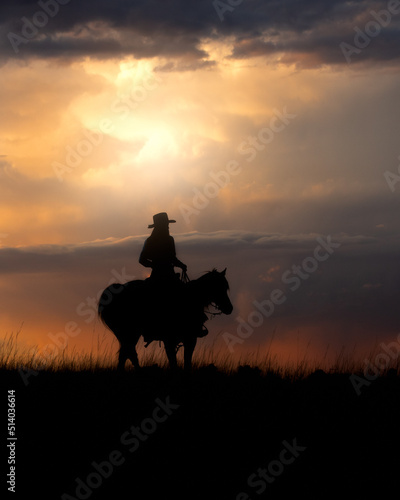 A cowgirl rides her horse at sunrise.  © FastHorsePhotography