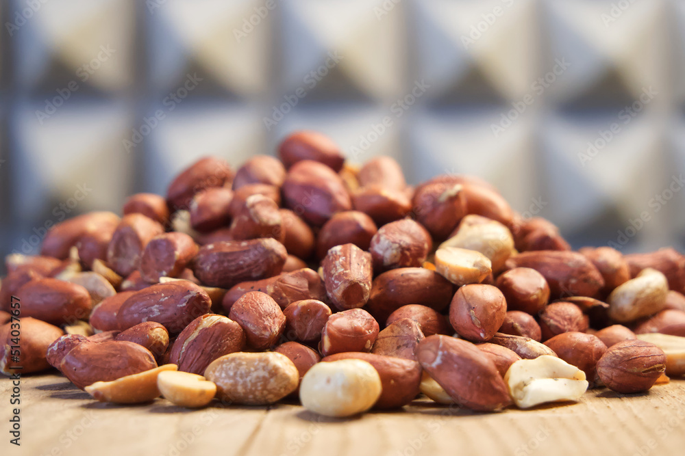Heap of roasted peanuts, side view. Peanuts close up. Nuts. Peanuts peeled and fried. Heap of roasted peanuts, side view. Peanuts close up. Nuts. Peanuts peeled and fried.