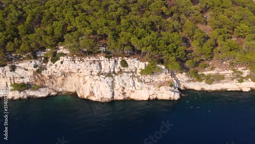 Rocky coastline of Croatia with turquoise water at sunset, near the city of Makarska. Aerial view of Makarska. Adriatic coast aerial view in high quality 4k.