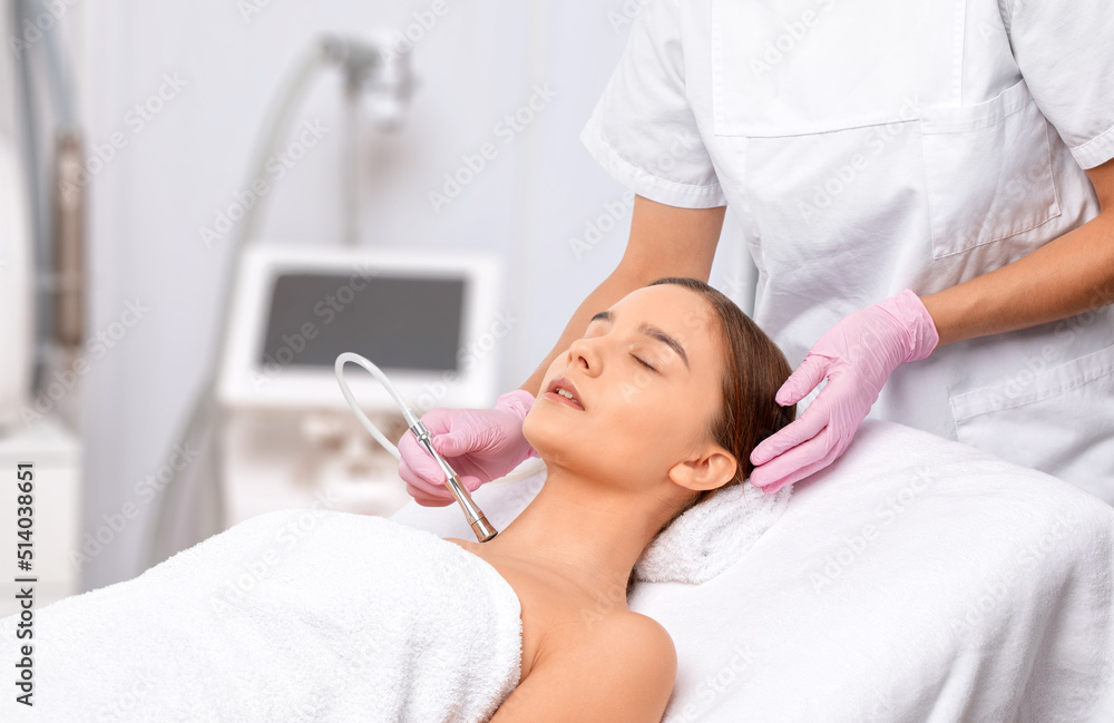 Procedure microdermabrasion on the face against acne and blackheads. Women's cosmetology in the beauty salon. Procedure microdermabrasion on the face against acne and blackheads. Women's cosmetology in the beauty salon.
