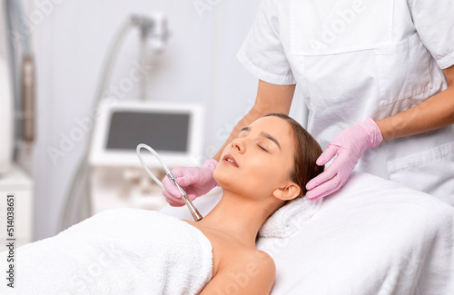 Procedure microdermabrasion on the face against acne and blackheads. Women's cosmetology in the beauty salon.