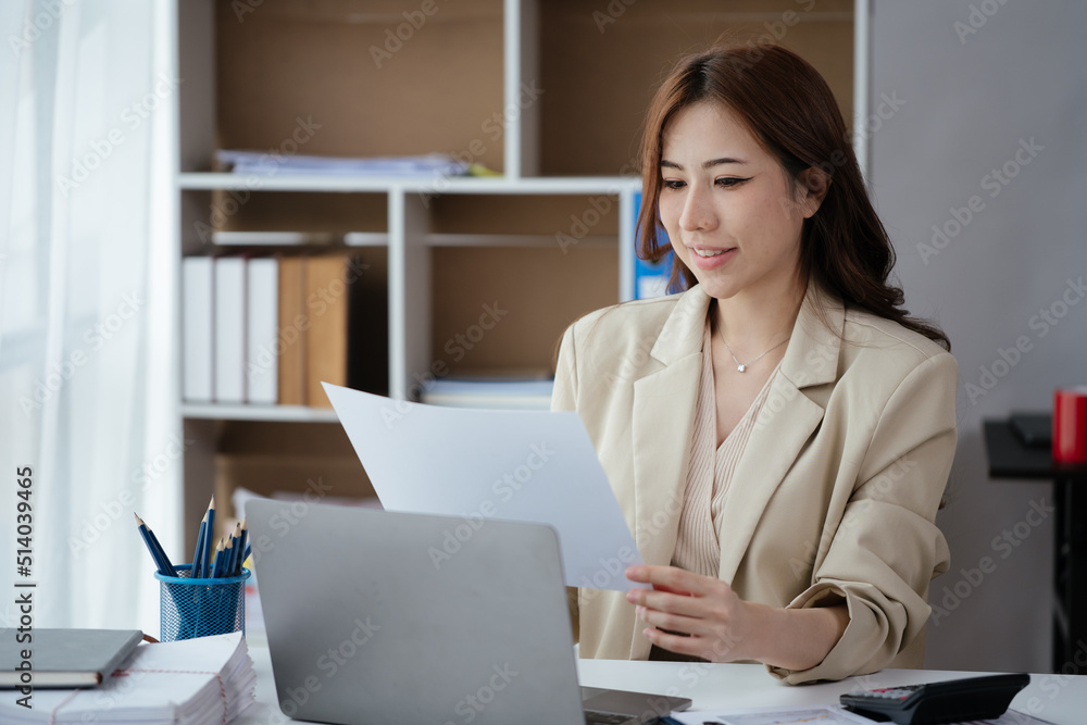 Happy smiling business woman using laptop for working and study at home or office space.