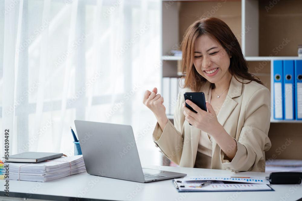 Business woman happy and cheerful for successful on project via mobile phone in office space. Business woman happy and cheerful for successful on project via mobile phone in office space.