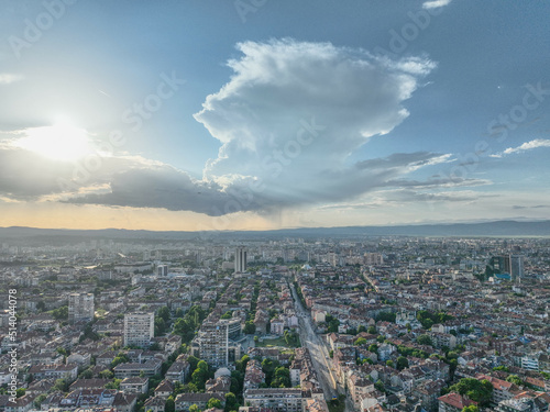View of the city. Clouds and god rays sun.