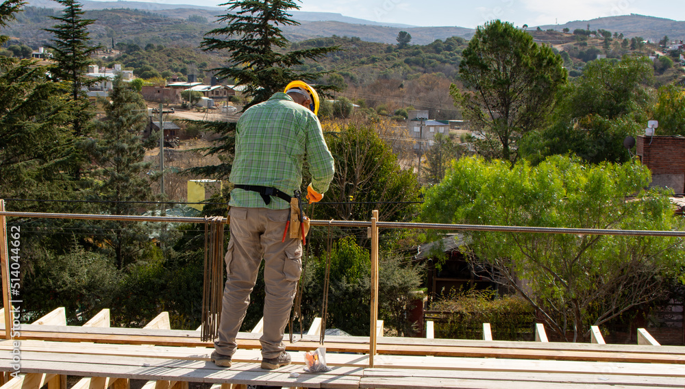 bricklayers with yellow helmet and protective glasses building an iron beam for reinforced concrete - PHOTO SESSION: WORK IN CONSTRUCTION bricklayers with yellow helmet and protective glasses building an iron beam for reinforced concrete - PHOTO SESSION: WORK IN CONSTRUCTION