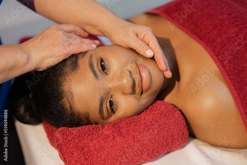 african woman in yellow towel on facial massage 