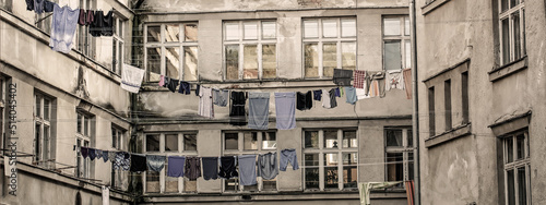 Washed clothes drying outside of an old house. Washed clothes drying. Fresh clean clothes are drying outside. Clothes hanging to dry on a clothes-line. Laundry dryings on the rope