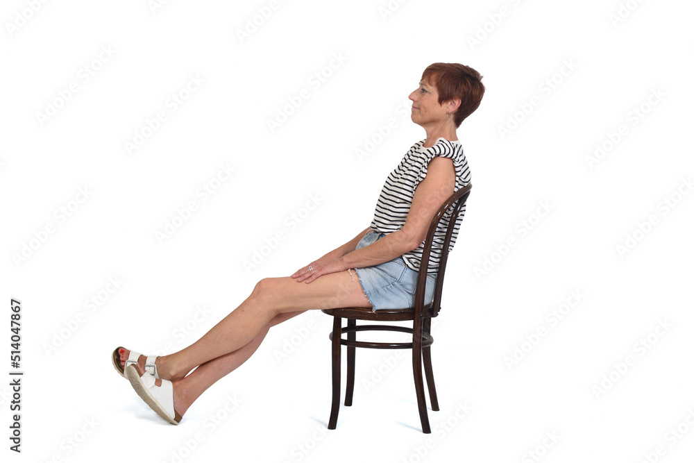 middle aged woman sitting on chair with stretched legs on white background middle aged woman sitting on chair with stretched legs on white background