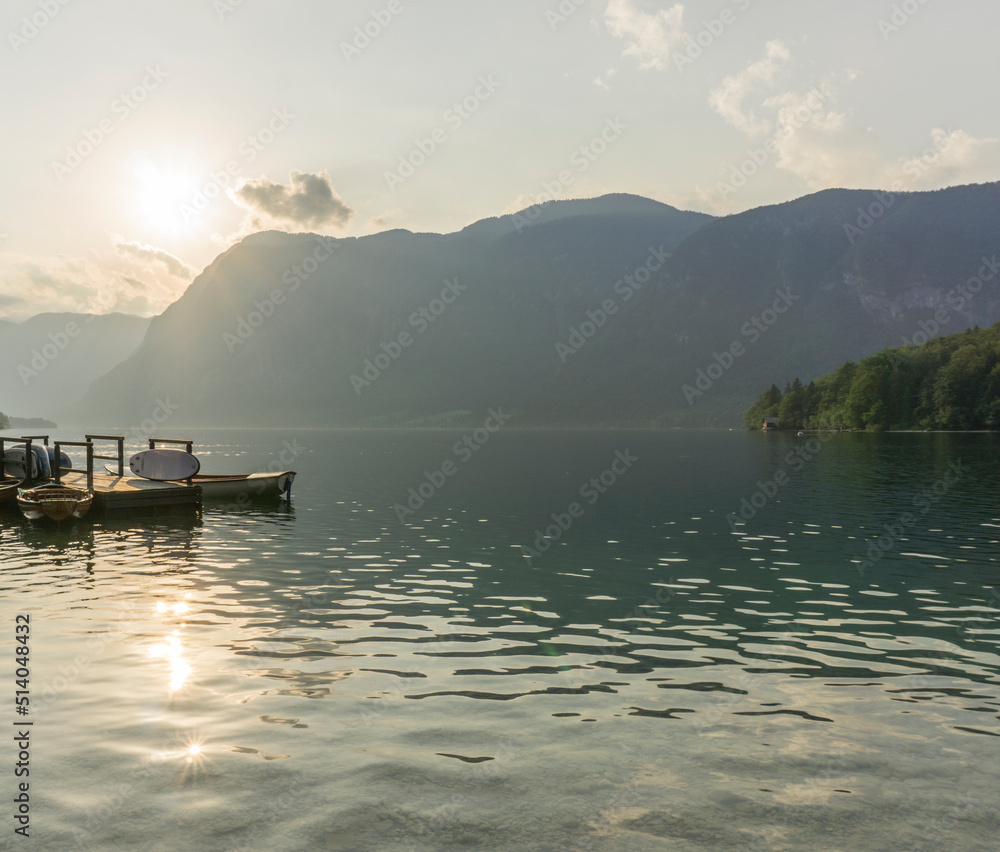 Beautiful forest reflection in the Bohinj lake with surrounding mountains Beautiful forest reflection in the Bohinj lake with surrounding mountains