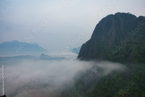 Sunrise over the smoged rice fields taken from Pha Ngern view point near Vang Vieng, Laos, Asia © SimonMichael