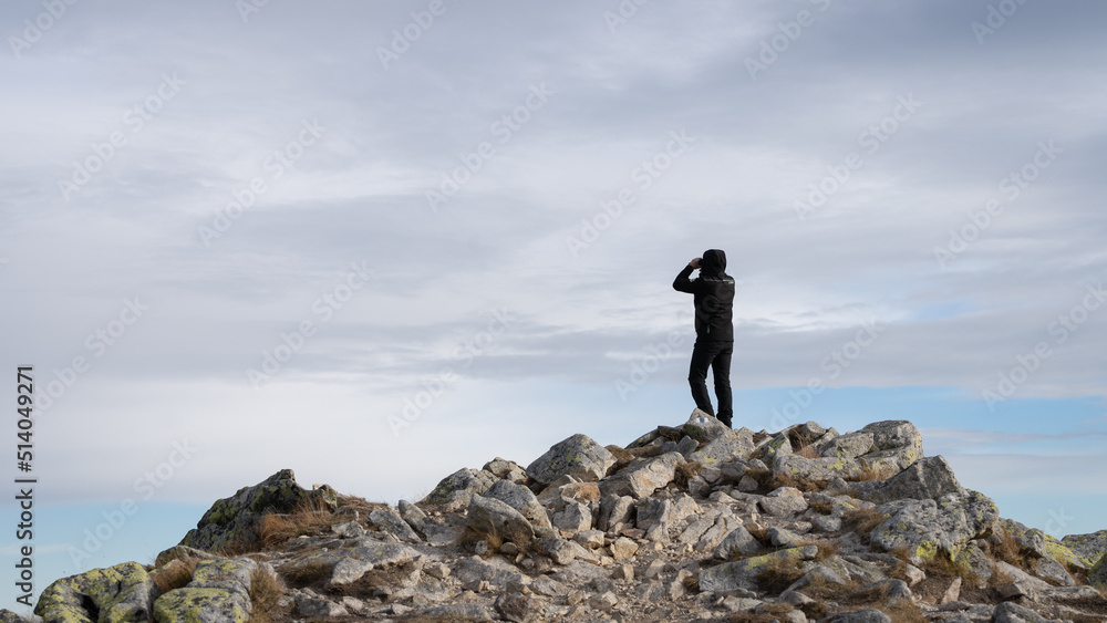 Man using binoculars on the mountain summit, Slovakia, Europe