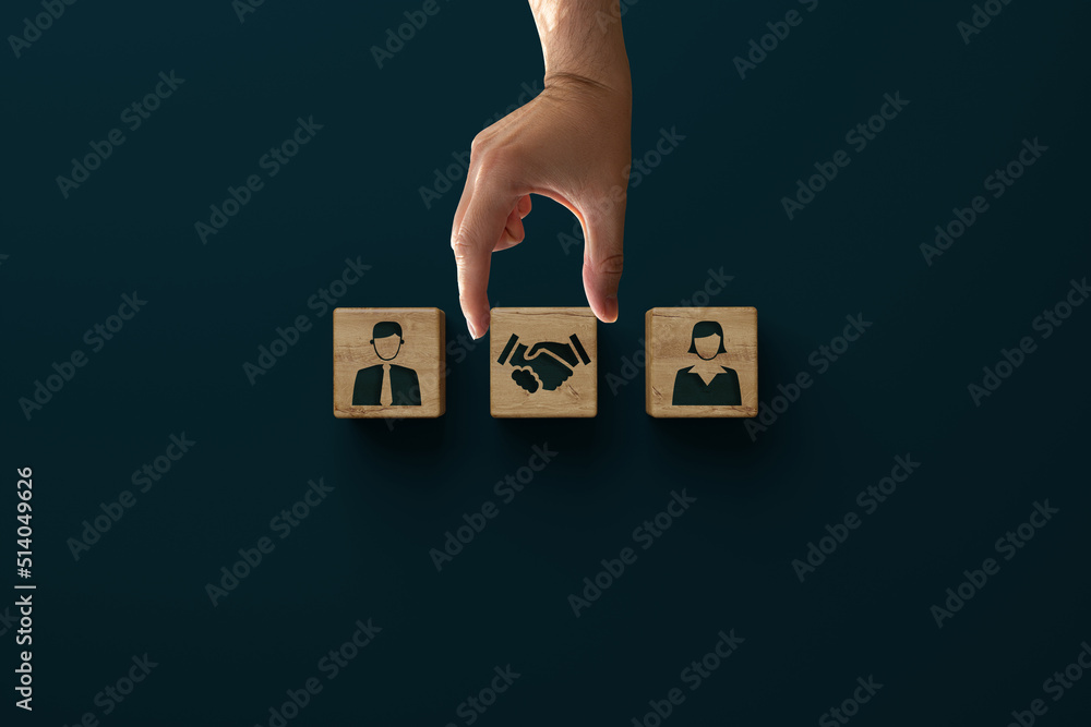 Wooden blocks with an icon of a man, woman and shaking hands with consent. Divorce, mediation concept. Troubleshooting by a mediator. - obrazy, fototapety, plakaty 