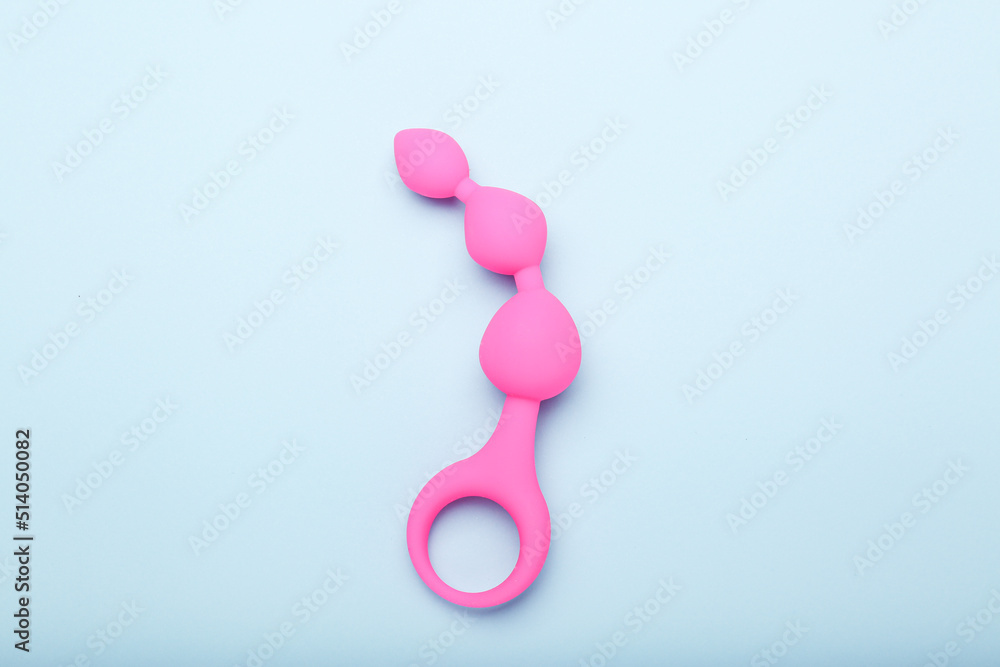 pink sex toy on blue background, adult toy for alternative sex pink sex toy on blue background, adult toy for alternative sex