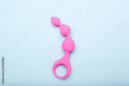 pink sex toy on blue background, adult toy for alternative sex