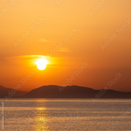 Sea beach and colorful sunset sky. Panoramic beach landscape. Tropical beach and seascape and a distant island in the background. Orange and golden sunset sky  calmness  tranquil sunlight.