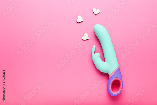 multi-colored sex toy, adult toy on a pink background photo