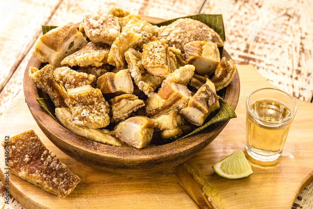 Fototapeta premium Crackling bowl, Brazilian appetizer made by frying bacon, leather or meat and lots of fat, taken from the pork belly.