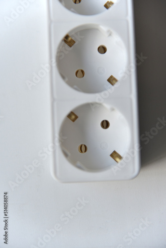 White electrical extension cord mains filter with sockets on a white background