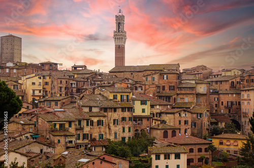 Beautiful Siena view of Tuscany, Italy. Palazzo Pubblico with Italian brick houses.