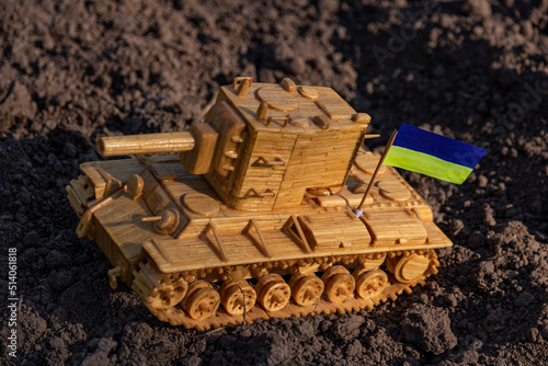 Tank on the ground with the flag of Ukraine close up