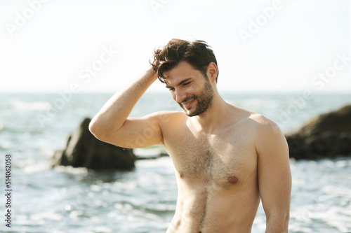 Young smiling man portrait near ocean