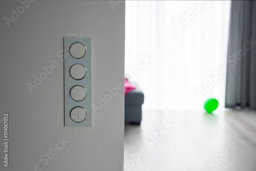 quad wall switch with the living room in the background