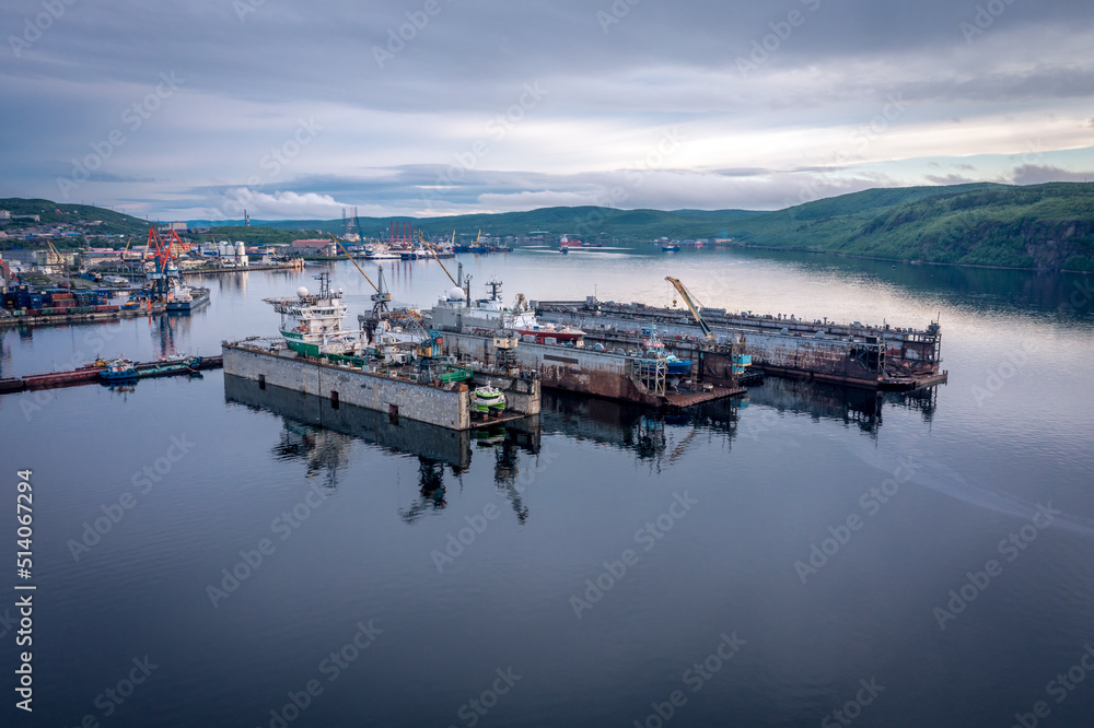 Fototapeta premium Panoramic aerial view of the port of Murmansk, ships and ship docks. Summer landscape in the north of Russia. Kola Bay of the Barents Sea