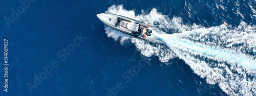 Aerial drone ultra wide photo with copy space of luxury rigid inflatable speed boat cruising in high speed in Aegean deep blue sea, Greece photo
