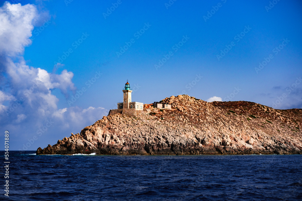 Cape Matapan Lighthouse, Cape Tainaron, Mani, Greece - 27 August 2021 : old european style building, rocky coast, sea, clouds, sky, southernmost point of mainland Greece