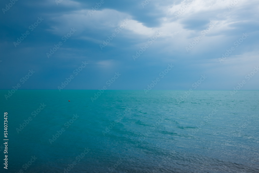 blue sea and cloudy sky on sunny summer day.