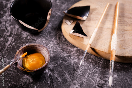 Bowl with a golden ointment for the art of kintsugi.