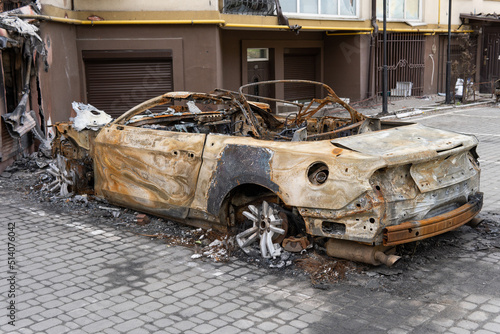 arson for revenge. burnt car parked on the street, close-up.