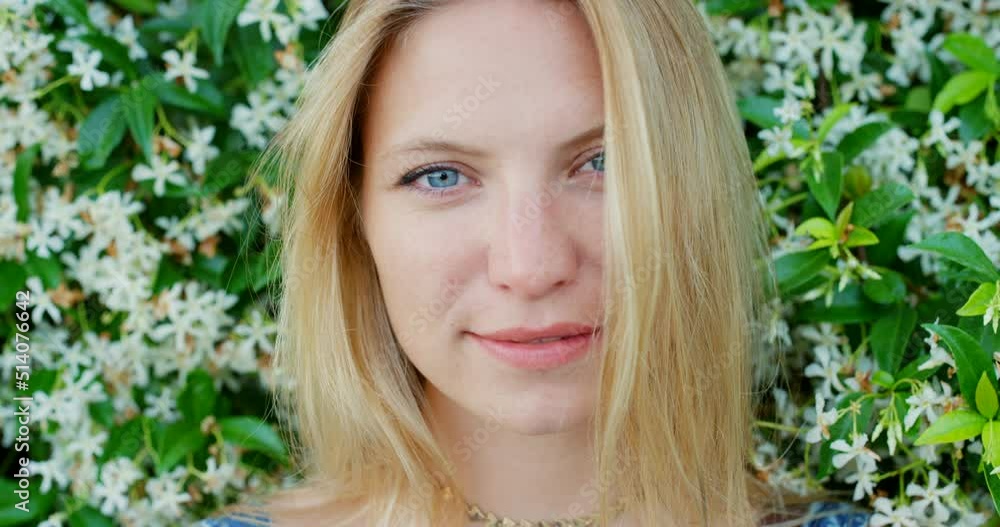 Portrait beautiful woman smiling in front of wall of ivy plants on summer vacation Portrait beautiful woman smiling in front of wall of ivy plants on summer vacation