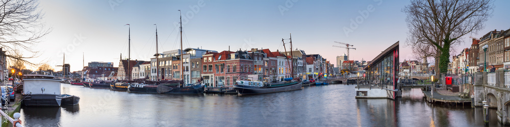 Cityscape, panorama, banner - view of city channel with ships, the city of Leiden, Netherlands.