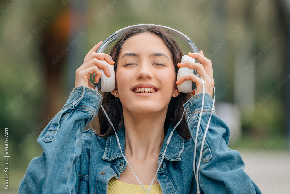 girl with headphones on the street outdoors girl with headphones on the street outdoors