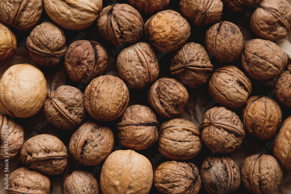 Walnuts with shells filling the image. Background of fresh walnuts. Walnuts with shells filling the image. Background of fresh walnuts.