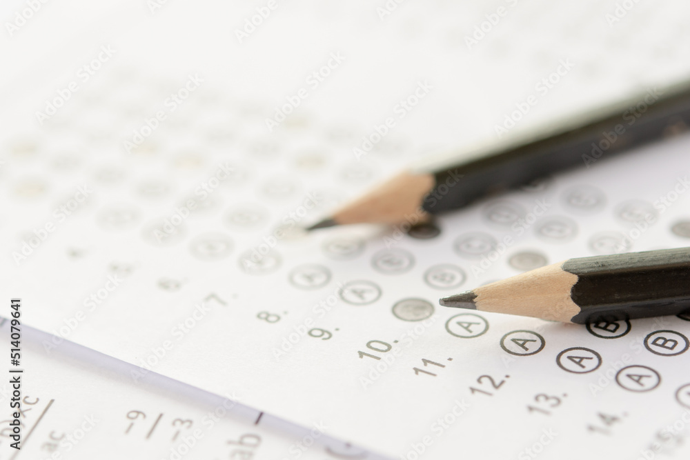 Pencil on answer sheets or Standardized test form with answers bubbled. multiple choice answer sheet Pencil on answer sheets or Standardized test form with answers bubbled. multiple choice answer sheet