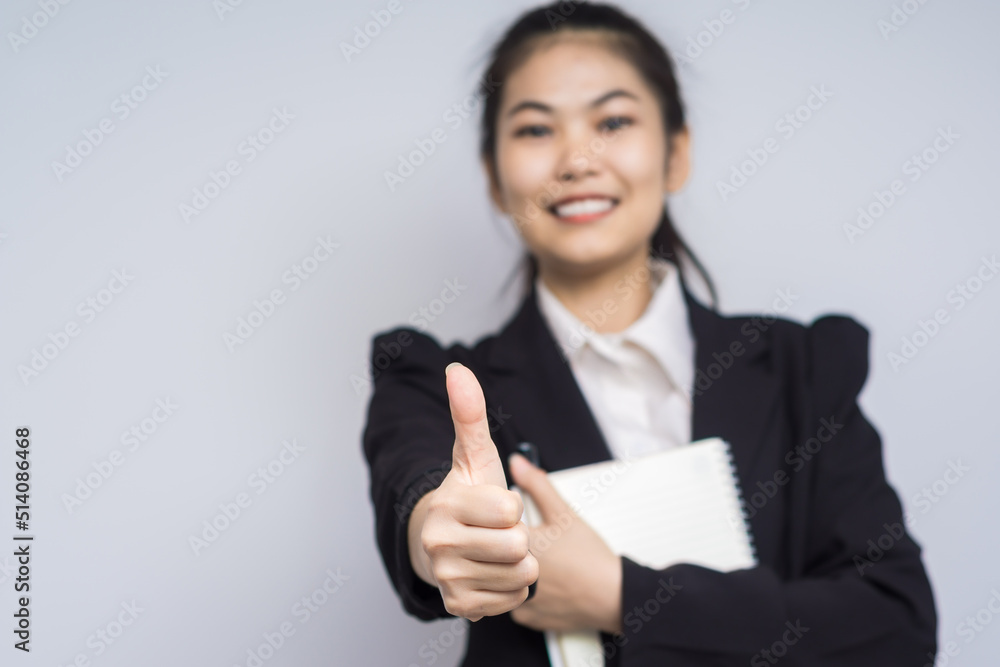 Smiling business women with pen and note reminder on white background Smiling business women with pen and note reminder on white background