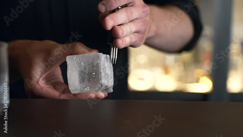 bartender prepares a cocktail in a bar, club. pours alcohol and syrups. uses ice and breaks ice
