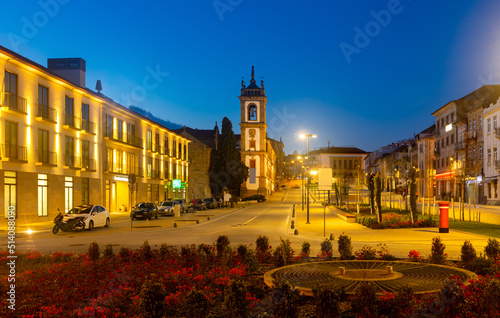 Evening spring view of illuminated Carvalho Araujo Avenue with belfry of cathedral in central part of Vila Real, Portugal. photo