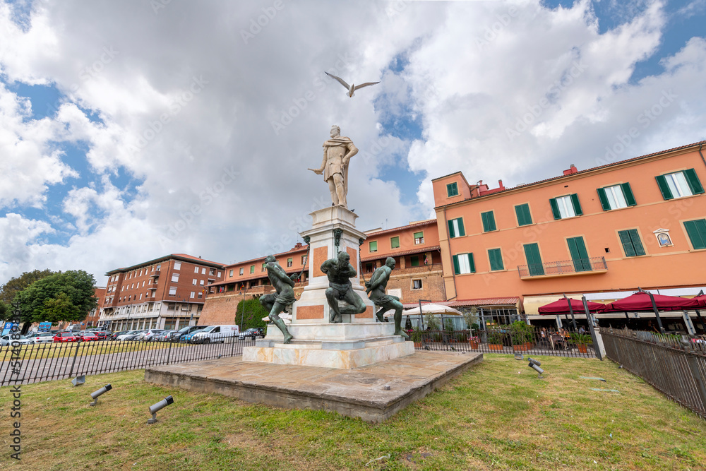 A seagull flies over the historic statue, Monument of the Four Moors