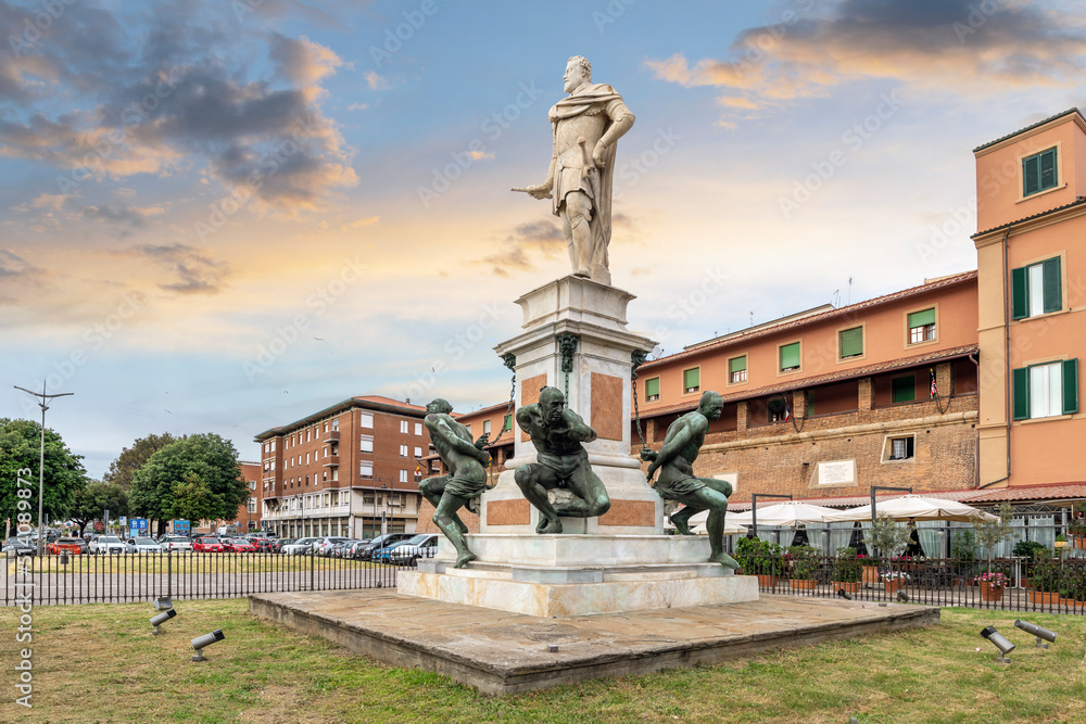 The historic statue, Monument of the Four Moors which depicts the duke Ferdinand I with four Moorish slaves as reminder of Livorno's slave market, at the Livorno, Italy port at early evening.