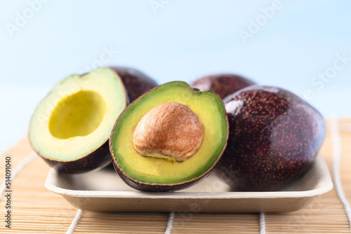 Ripe avocado fruit on plate ready to eating, Tropical fruit
