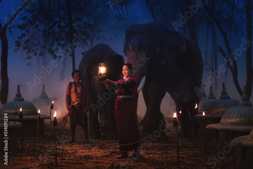 Photography Thai tourist woman with elephant trainer and elephants at elephants cemetery in
