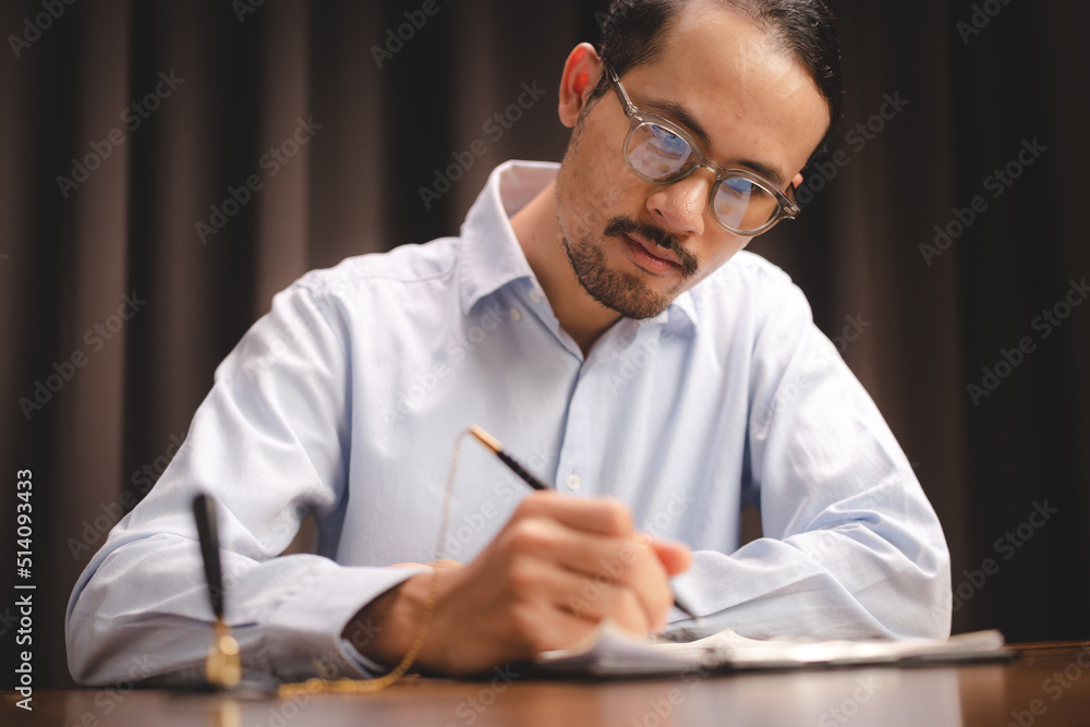 young Asian businessman working on paper document business work in modern office, professional man are happy to startup corporate with new teamwork person by using a business plan to work young Asian businessman working on paper document business work in modern office, professional man are happy to startup corporate with new teamwork person by using a business plan to work