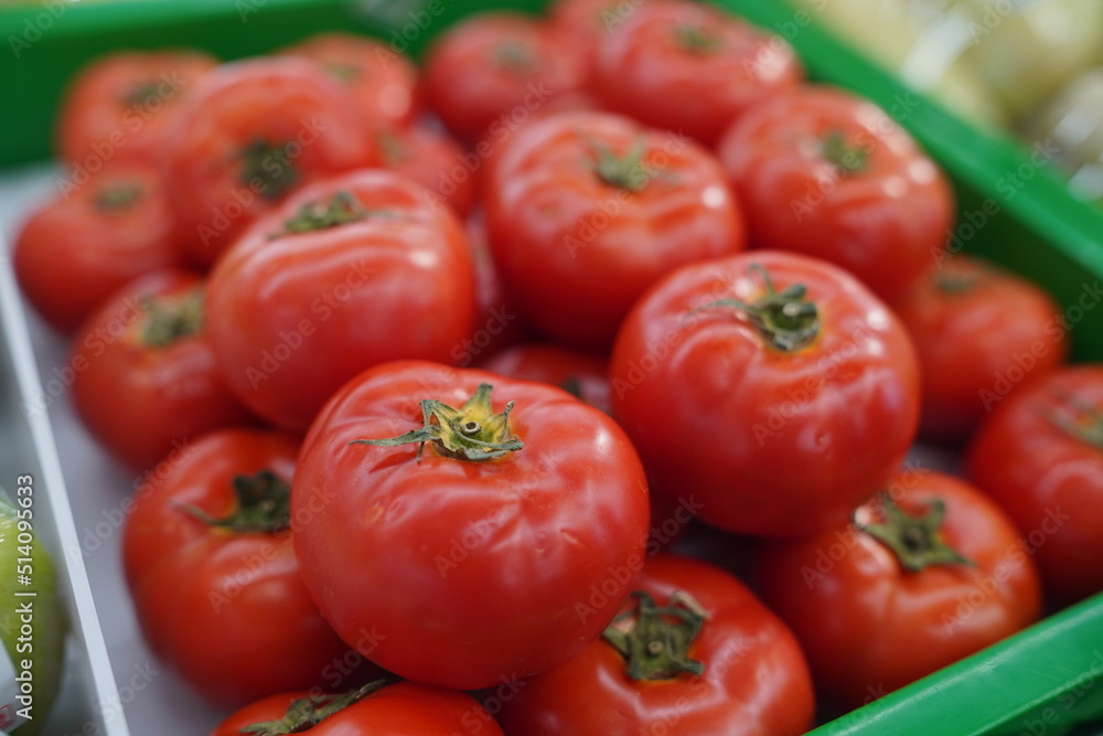 Close-up Red ripe tomatoes. Background or texture of tomatoes. Lots of red tomatoes. Harvesting tomatoes. Close-up Red ripe tomatoes. Background or texture of tomatoes. Lots of red tomatoes. Harvesting tomatoes.